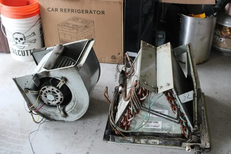 Dirty evaporator coil and blower motor removed from a Fort Myers AC system that was not maintained