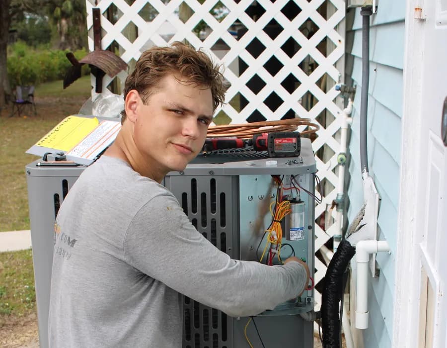 Big Air technician diagnosing the electrical panel of an AC condenser at a Fort Myers home